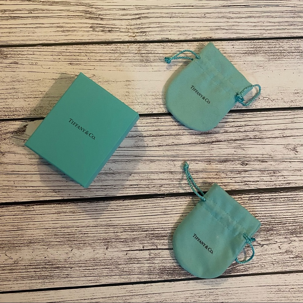 Tiffany & Co packaging: 2 drawstring pouches and one box.